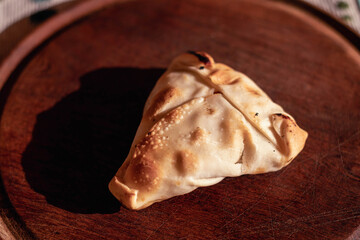 Arabic empanadas on wooden plate with natural light