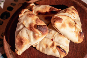 Arabic empanadas on wooden plate with natural light