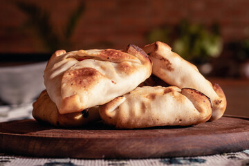Arabic empanadas on wooden plate with natural light