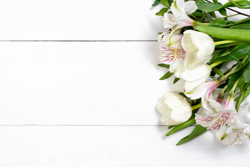 composition of white flowers on a white wooden background with copy space. holiday and congratulations concept