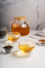 light tea flatley. pour black tea into thermos cups, on a light background. tea ceremony with different types of leaf tea