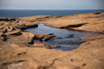 Rock pool formation along coastline 