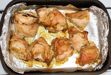 Grilled browned the chicken thighs on the baking sheet with foil. Top view.