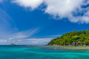 Ile Moyenne island and a small Ile Seche islet on the background in the Saint-Anne Marine National Park in Seychelles on a sunny day