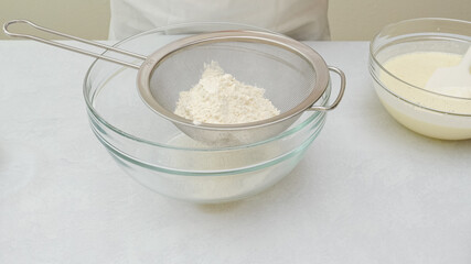 Chocolate cake step by step recipe. Mixing dry ingredients in a glass bowl