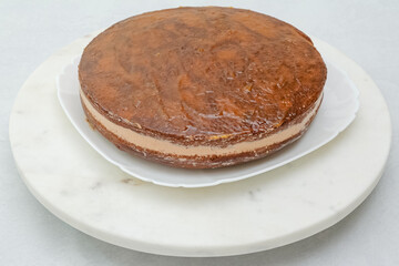 Chocolate cake with chocolate cream frosting step by step recipe. Assembling the cake, topping cake with apricot jam
