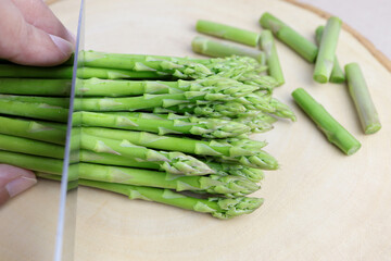 Fresh green asparagus on cutting board.