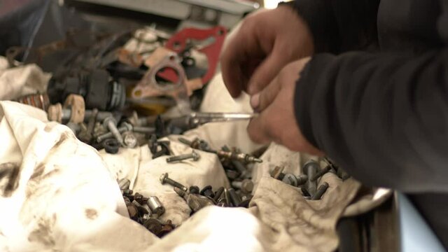 The Craftsman Serviceman Car  In The Repair Shop Lets The Suitable Screws While Gathering