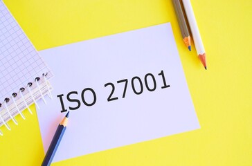 Iso 27001 text concept written on white paper. Business photo specification for an information security analysisagement system