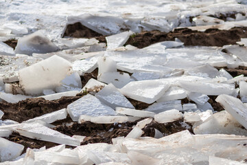 Broken ice surface of a lake in December and January as cold frosty winter season shows cracked ice of an arctic glacier with frozen water and thick ice on a scenic river in winter climate