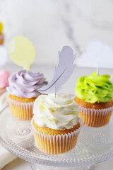 Tasty cupcakes with stylish toppers on light background