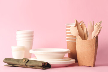 Eco tableware and container on color background