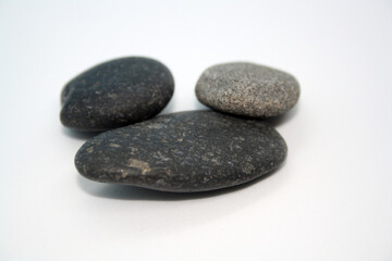 Sea round stones on a white background. Selective focus.