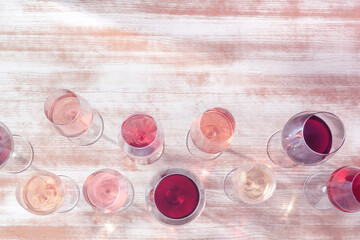 Wine colours. White, rose, and red wine glasses, shot from the top with copy space, toned image