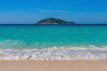 Fototapeta na wymiar Tropical islands view of ocean blue sea wave water and white sand beach, nature landscape in Thailand