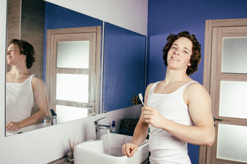 Handsome young man in the bathroom. Morning and hygiene.


morning