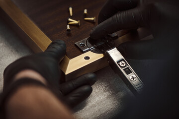 Installation of furniture fittings. Assembly of furniture strip. Carpenter assembles slats