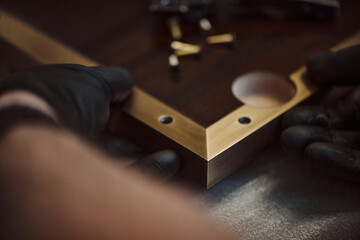 Installation of furniture fittings. Assembly of furniture strip. Carpenter assembles slats