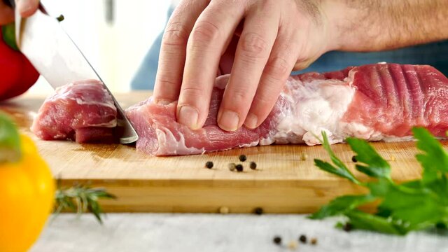 cutting filet mignon on wooden board