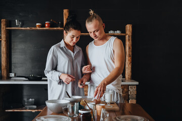 Beautiful couple preparing a meal together while spending free time at home.