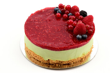 Loose sand crumbs cake with natural pistachio paste mousse, decorated with fresh raspberries, lingonberries and blueberries