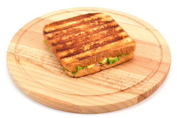 Hot sandwich with cheese, sausage and green salad, on a wooden cutting board isolated on white background