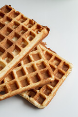 gripping waffles in a waffle iron. Belgian wali in preparation. view from above. close-up. place for the recipe.