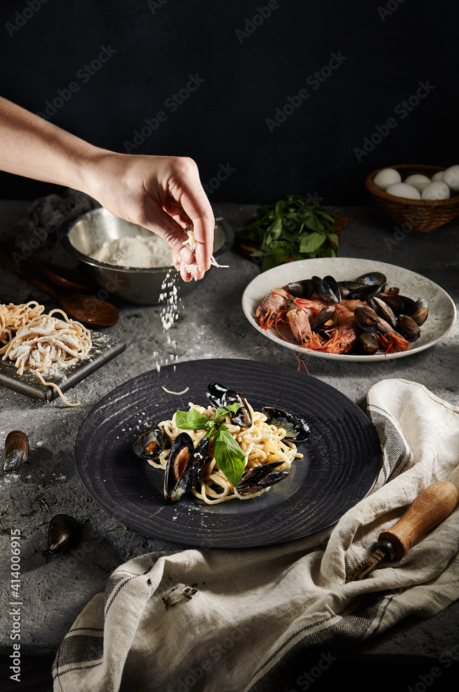 Wall mural home made pasta with seafood and green leaf. gray vintage table and cloth. tasty pasta with mussels