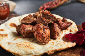 Kebab  with garnish on flatbread