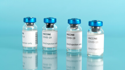 Coronavirus vaccine vial. Covid vaccination with vaccine glass bottles. Blue medical background. Selective focus.