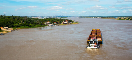 The wide Paraguay River with brown water in capital city Asuncion