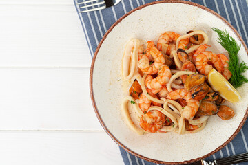 Stir fried seafood with sauce on plate with napkin
