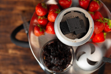 Hookah with strawberry flavour close up on dark background