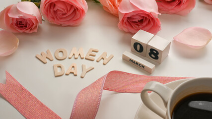 8 March Happy Women's day on white table with coffee cup, pink roses flower and ribbon