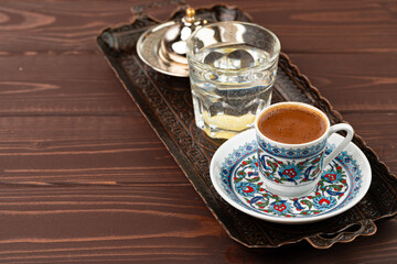 Cup of coffee in oriental style on metal tray