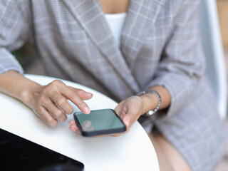 Female hand using smartphone while takes short time-out in office work