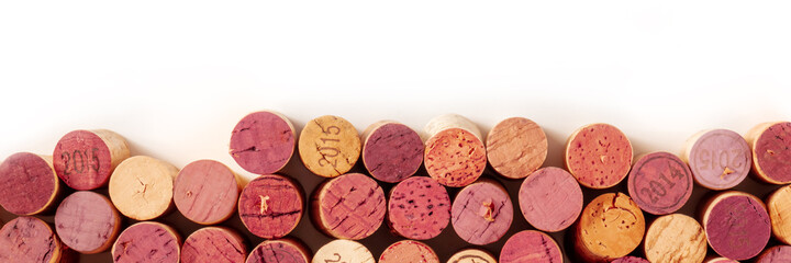 Obraz na płótnie Canvas Wine corks panorama with copy space, overhead shot on a white background, a design template