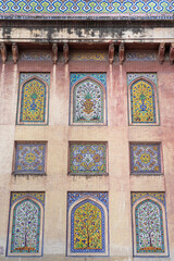 Colorful kashi-kari or faience tile mosaic pannels with floral and geometric design on ancient mughal era Wazir Khan mosque in the walled city of Lahore, Punjab, Pakistan