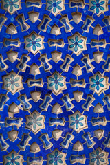 Closeup detail of bright blue and white ceramic geometric and floral design on wall of historic Shah Rukn-e-Alam sufi mausoleum in Multan, Punjab, Pakistan