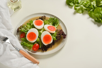 A plate of of salad with boiled eggs, lettuce and tomato, easter brunch