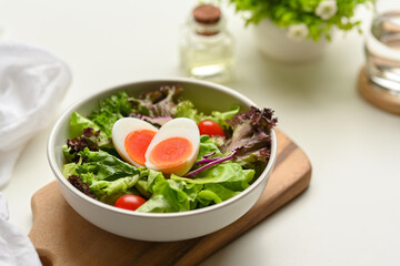 Close up view of a plate of of salad with boiled eggs, lettuce and tomato, easter brunch
