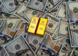 gold bars on 100 new US dollar banknotes