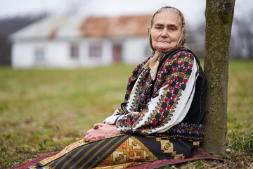 Old Romanian woman outdoor in the garden