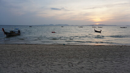 Fototapeta premium sunset and boats at the Khlong Muang Beach in Nong Thale, Krabi, Southern Thailand, March