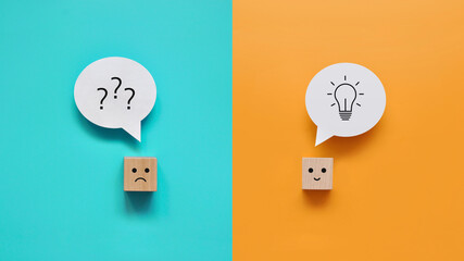 Cubes: one is sad with a question in his head and the second is cheerful with a solution in his...