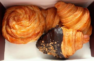 mixed kind of fresh croissants inside box