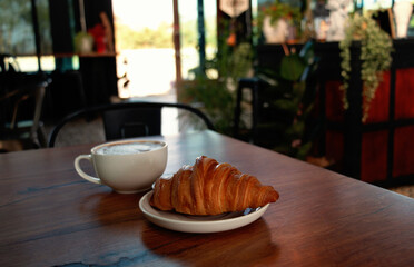 croissant and coffee on table for breakfast