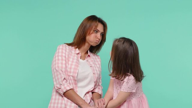 Woman in pink clothes have fun with cute child baby girl 5-6 years old blow air cheeks. Mommy little kid daughter isolated on pastel blue background studio Mother's Day love family parenthood concept