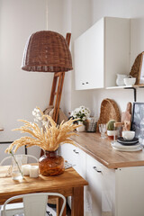 Modern minimal home interior in eco style. A natural bright apartment in trendly style. Decorative straw lamp.
