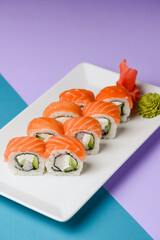 Maki Sushi - Roll made of smoked salmon and cream cheese. Traditional Japanese cuisine concept, over pastel purple.